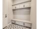 Mudroom features a bench with storage underneath and overhead cabinets with black hardware at 2978 Newfound Lake Rd, Berthoud, CO 80513