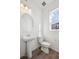 Clean bathroom featuring a pedestal sink, new fixtures, and ample lighting at 1264 Penner Dr, Erie, CO 80026