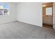 A bright bedroom with a neutral carpet leads into an ensuite bathroom at 1264 Penner Dr, Erie, CO 80026