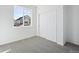 Bedroom featuring neutral carpet, a large window, and a spacious closet at 1264 Penner Dr, Erie, CO 80026