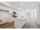 Modern kitchen with a large island, stainless steel appliances, and light colored cabinets at 1264 Penner Dr, Erie, CO 80026