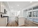 Bright kitchen with an island, stainless steel appliances, and sliding glass doors to the patio at 1264 Penner Dr, Erie, CO 80026