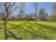 Expansive backyard with lush green lawn and mature trees, perfect for outdoor activities at 2991 S Fillmore Way, Denver, CO 80210