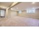 Bright, open basement area with multiple windows and carpeted floors at 2991 S Fillmore Way, Denver, CO 80210