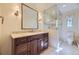 Elegant bathroom featuring marble countertops, a glass shower, and a dark wood vanity at 2991 S Fillmore Way, Denver, CO 80210