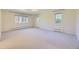 Large bedroom with neutral carpet, multiple windows, and baseboard heating at 2991 S Fillmore Way, Denver, CO 80210