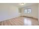 Light and airy bedroom with hardwood floors, built-in shelves, and a large window at 2991 S Fillmore Way, Denver, CO 80210