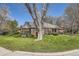 Beautifully landscaped front yard with a large mature tree, complemented by a brick home at 2991 S Fillmore Way, Denver, CO 80210
