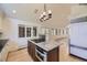 Stylish kitchen island with granite countertop, stainless oven, and hardwood floors throughout at 2991 S Fillmore Way, Denver, CO 80210