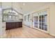 Bright eat-in kitchen featuring a large island, custom cabinets, and access to a patio through glass doors at 2991 S Fillmore Way, Denver, CO 80210