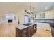 Open-concept kitchen with a granite island, stainless appliances, and hardwood flooring at 2991 S Fillmore Way, Denver, CO 80210