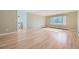 Airy living room featuring hardwood floors, natural light from large windows, and neutral wall color at 2991 S Fillmore Way, Denver, CO 80210