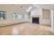 Sun-filled living room with a skylight, fireplace with custom shelving, and large windows at 2991 S Fillmore Way, Denver, CO 80210