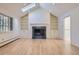 Cozy living room features a fireplace with custom shelving and large windows at 2991 S Fillmore Way, Denver, CO 80210