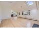 Spacious living room boasts a skylight, fireplace, and seamlessly connects to the bright and airy kitchen at 2991 S Fillmore Way, Denver, CO 80210
