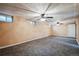 Spacious finished basement with neutral carpeting and ceiling fans at 8089 Greenwood Blvd, Denver, CO 80221