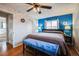 Main bedroom with blue accent wall and ceiling fan at 8089 Greenwood Blvd, Denver, CO 80221