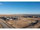 Expansive aerial view showcasing a large neighborhood with single-Gathering homes under a clear, blue sky at 26361 E 5Th Pl, Aurora, CO 80018