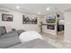 Finished basement offers a sectional, beanbag and fireplace with TV at 26361 E 5Th Pl, Aurora, CO 80018