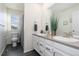 Bathroom featuring dual sinks, large mirror, and a separate area for the toilet and shower at 26361 E 5Th Pl, Aurora, CO 80018