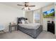 Bright bedroom with a ceiling fan, mounted TV, and neutral tones for versatile decor at 26361 E 5Th Pl, Aurora, CO 80018