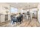 Bright dining area with modern table set, hardwood floors, and a kitchen with bar seating at 26361 E 5Th Pl, Aurora, CO 80018