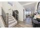 Inviting entryway featuring hardwood floors, stairs, and an open view to the living area at 26361 E 5Th Pl, Aurora, CO 80018