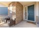 Inviting front porch with brick accent and welcome mat at 26361 E 5Th Pl, Aurora, CO 80018