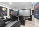 Finished basement featuring home theater with projector screen and tiered seating at 26361 E 5Th Pl, Aurora, CO 80018
