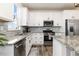 Bright and airy kitchen with stainless steel appliances, and granite countertops at 26361 E 5Th Pl, Aurora, CO 80018