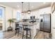 Modern kitchen with white cabinets, stainless steel appliances, and granite countertops at 26361 E 5Th Pl, Aurora, CO 80018