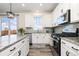 Modern kitchen with stainless steel appliances, granite countertops, and ample counter space at 26361 E 5Th Pl, Aurora, CO 80018
