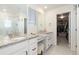 Beautiful primary bathroom with dual vanities, granite counters and a walk-in closet at 26361 E 5Th Pl, Aurora, CO 80018