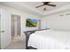 Spacious primary bedroom with a ceiling fan, tray ceiling, ensuite bath and mounted TV at 26361 E 5Th Pl, Aurora, CO 80018