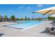 Community pool with clear water, lounge chairs and sun shades for residents to relax at 26361 E 5Th Pl, Aurora, CO 80018