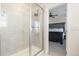 Attractive primary bathroom shower with gray tile, glass door, and views into the main bedroom at 26361 E 5Th Pl, Aurora, CO 80018