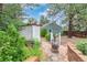 Private backyard oasis featuring a fire pit, lush landscaping, and a charming pergola-covered space at 881 S Pearl St, Elizabeth, CO 80107
