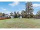 Expansive backyard featuring a shed, gazebo, mature trees, and a wooden fence at 881 S Pearl St, Elizabeth, CO 80107
