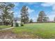 Lush backyard with a gazebo, mature trees, and a spacious lawn for outdoor enjoyment at 881 S Pearl St, Elizabeth, CO 80107
