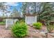 Private backyard featuring a garden feature with bridge, seating area, and beautiful landscaping at 881 S Pearl St, Elizabeth, CO 80107