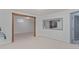 Unfurnished basement with light carpet, white walls and wooden doorframe at 881 S Pearl St, Elizabeth, CO 80107