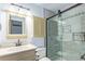 Bright bathroom featuring updated walk-in shower with sleek glass door, stylish vanity, and ample lighting at 881 S Pearl St, Elizabeth, CO 80107
