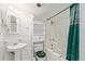 All-white bathroom with shower-tub combo and decorative shower curtain at 881 S Pearl St, Elizabeth, CO 80107