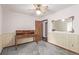 Neutral bedroom with a ceiling fan, desk, and decorative mirror at 881 S Pearl St, Elizabeth, CO 80107