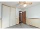 Bedroom with gray carpet, sliding closet doors, adjacent room visible through doorway, and ceiling fan at 881 S Pearl St, Elizabeth, CO 80107