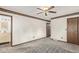 Spacious bedroom includes carpet, ceiling fan, and a glimpse into the en-suite bathroom at 881 S Pearl St, Elizabeth, CO 80107