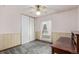Bedroom features gray carpeting, a window with white curtains, and a large built-in desk at 881 S Pearl St, Elizabeth, CO 80107