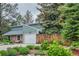 Inviting home featuring stone accents, a two-car garage, mature trees and landscaping for added curb appeal at 881 S Pearl St, Elizabeth, CO 80107