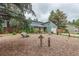 View of charming home with stone accents and a well-manicured front yard featuring rock landscaping and a garden at 881 S Pearl St, Elizabeth, CO 80107
