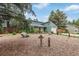 View of charming home with stone accents and a well-manicured front yard featuring rock landscaping and a garden at 881 S Pearl St, Elizabeth, CO 80107